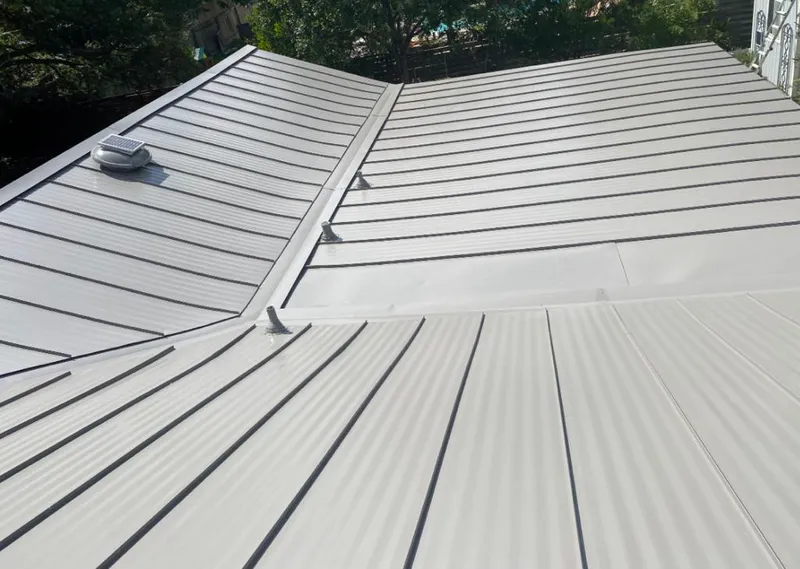 Solar attic fan installed on a metal roof for Roof Ventilation in White City